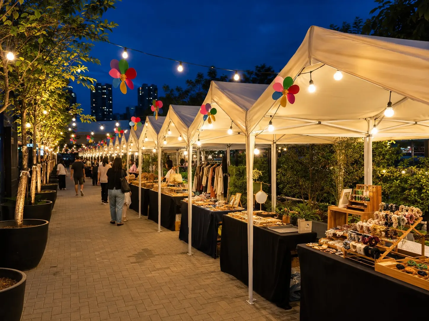 Night market bazaar stall rental scene in Malaysia with white stall tents, hanging lights, retail displays and visitors strolling along the pathway