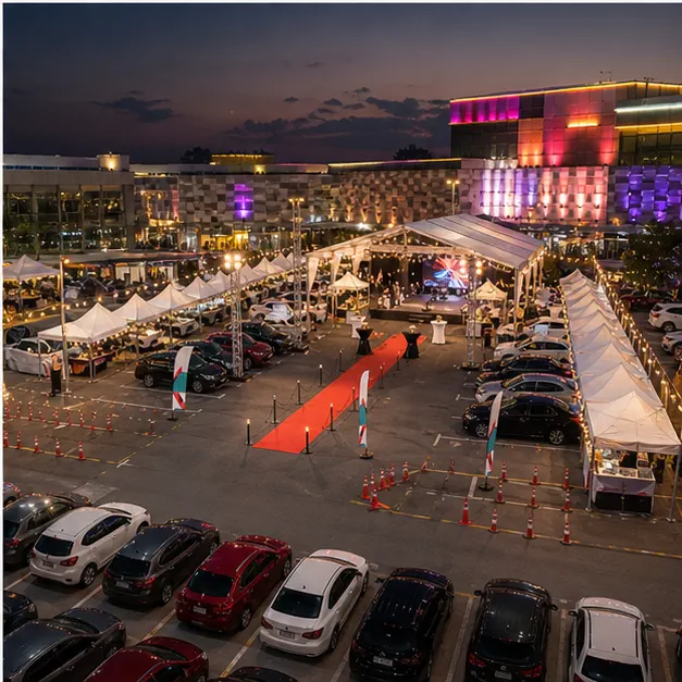 High angle view of a mall car park night market layout with festival marquee, launch booth, vendor rows, entertainment area and lighting towers