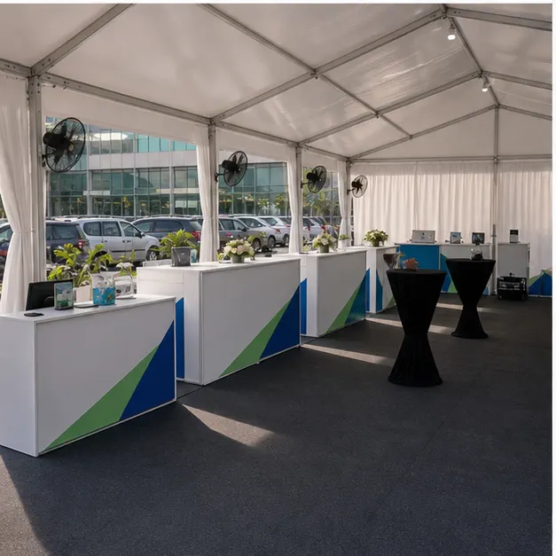 Side view of hospital support marquee with staff briefing area, counters, queue barriers and shaded pedestrian route