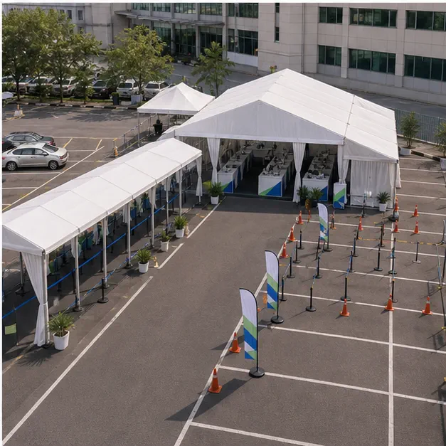 High angle view of a hospital outdoor support layout with waiting marquee, queue cover, support counters and car park access
