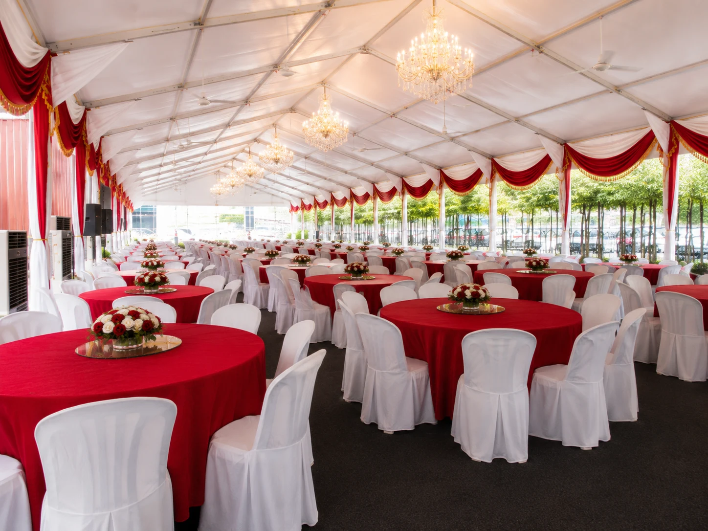 Side angle of Eco Ardence Setia Alam wedding banquet marquee with round dining tables, clear roof cover, drapes and floral event styling