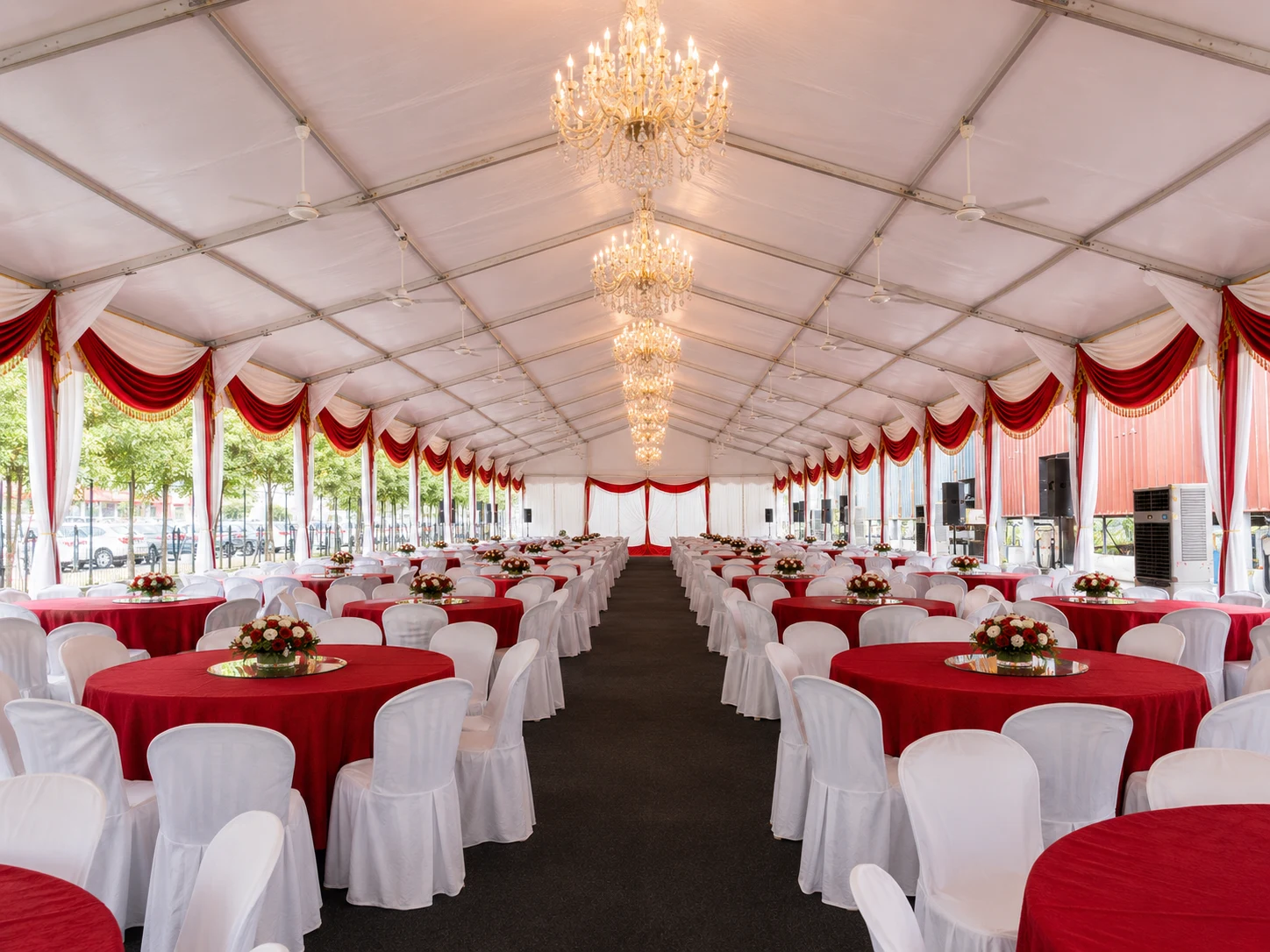 Interior angle of Eco Ardence Setia Alam wedding banquet marquee with guest dining layout, clear roof cover, decorative drapes and floral centrepieces