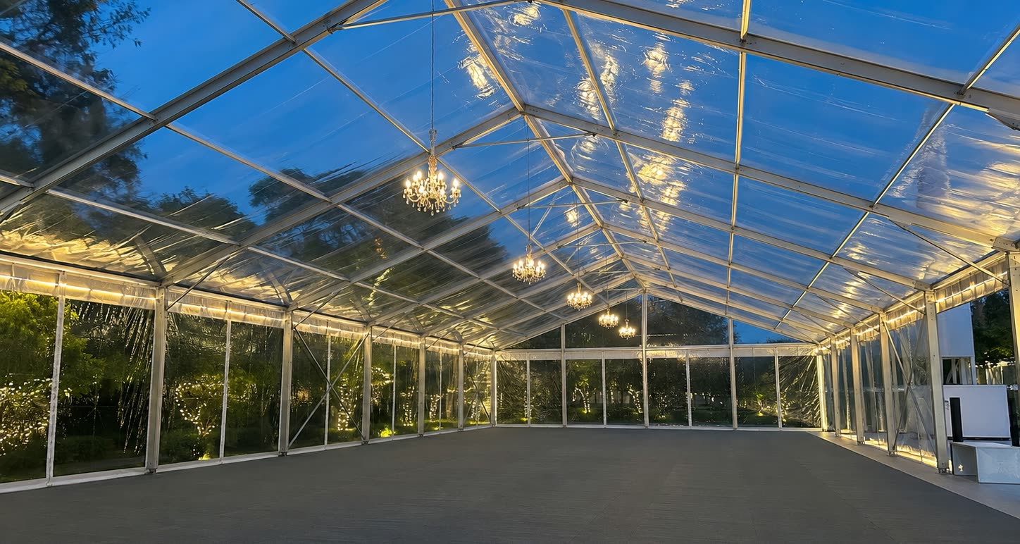 Empty clear roof marquee interior with warm chandeliers and open floor layout