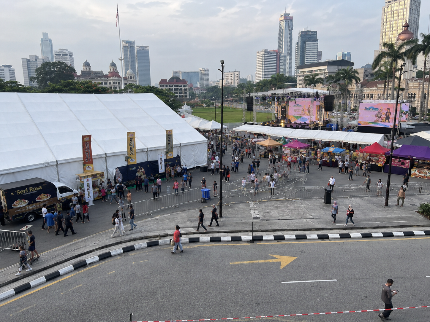 Portfolio concept example of a Kuala Lumpur civic field public celebration bazaar setup with large marquee tent, booth canopy rows, stage, LED screen and city event layout