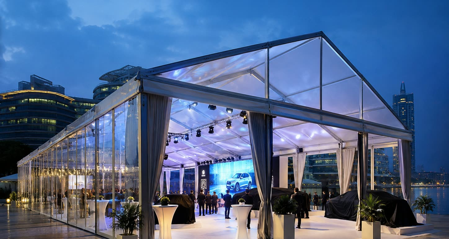 City product launch transparent marquee at night with stage lighting and cocktail tables