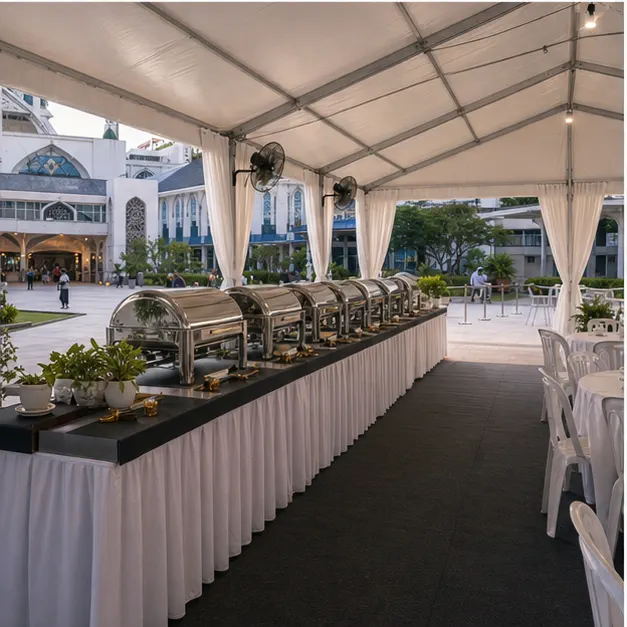Side view of mosque compound marquee setup with buffet counters, covered seating, service route and white drapes