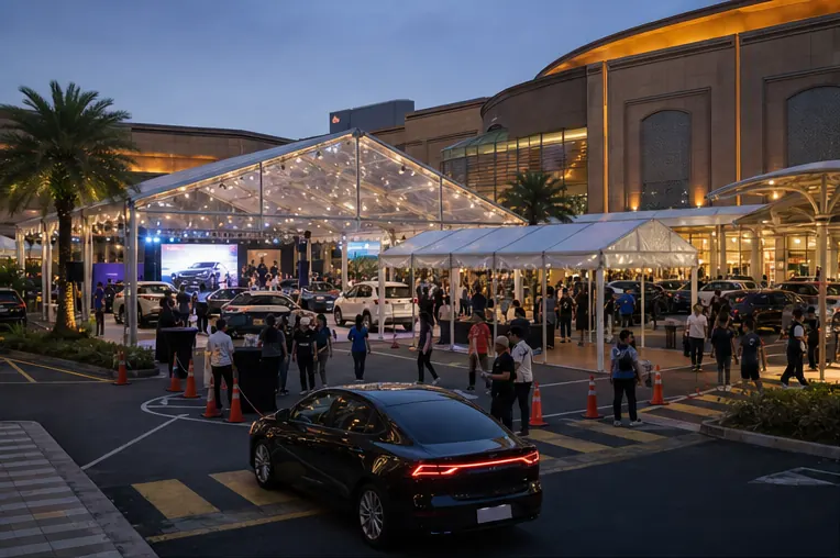 Sunway Pyramid automotive launch setup with clear span marquee, covered walkway, display cars, queue lanes and evening mall lighting