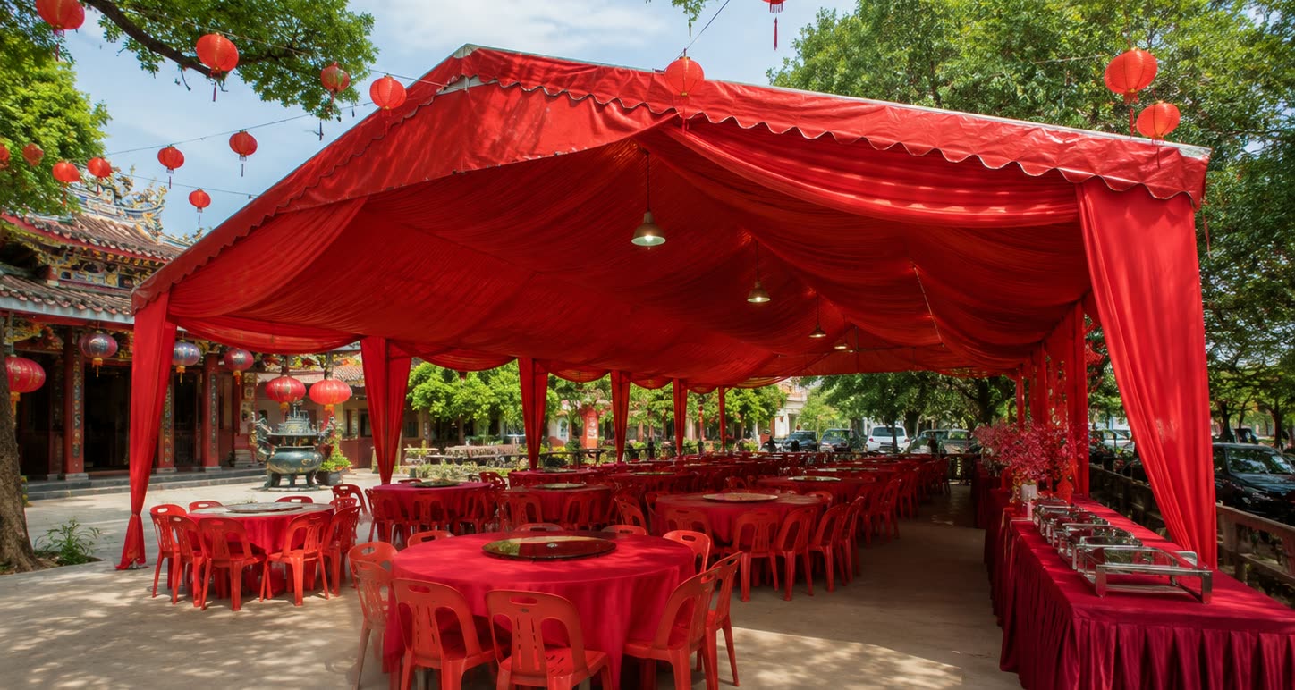 Temple compound red canopy banquet setup with round tables and buffet counters