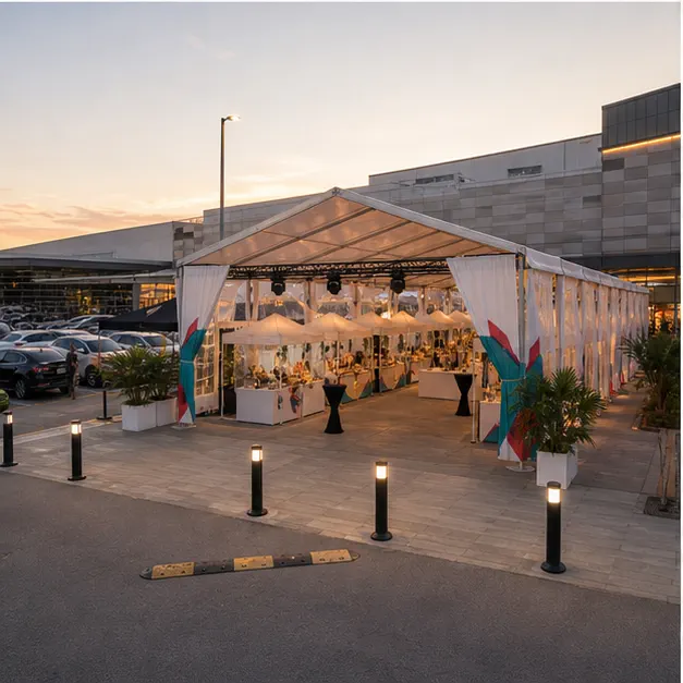 Side view of a mall outdoor concourse bazaar setup with modular canopy rows, guest route and lifestyle booth displays