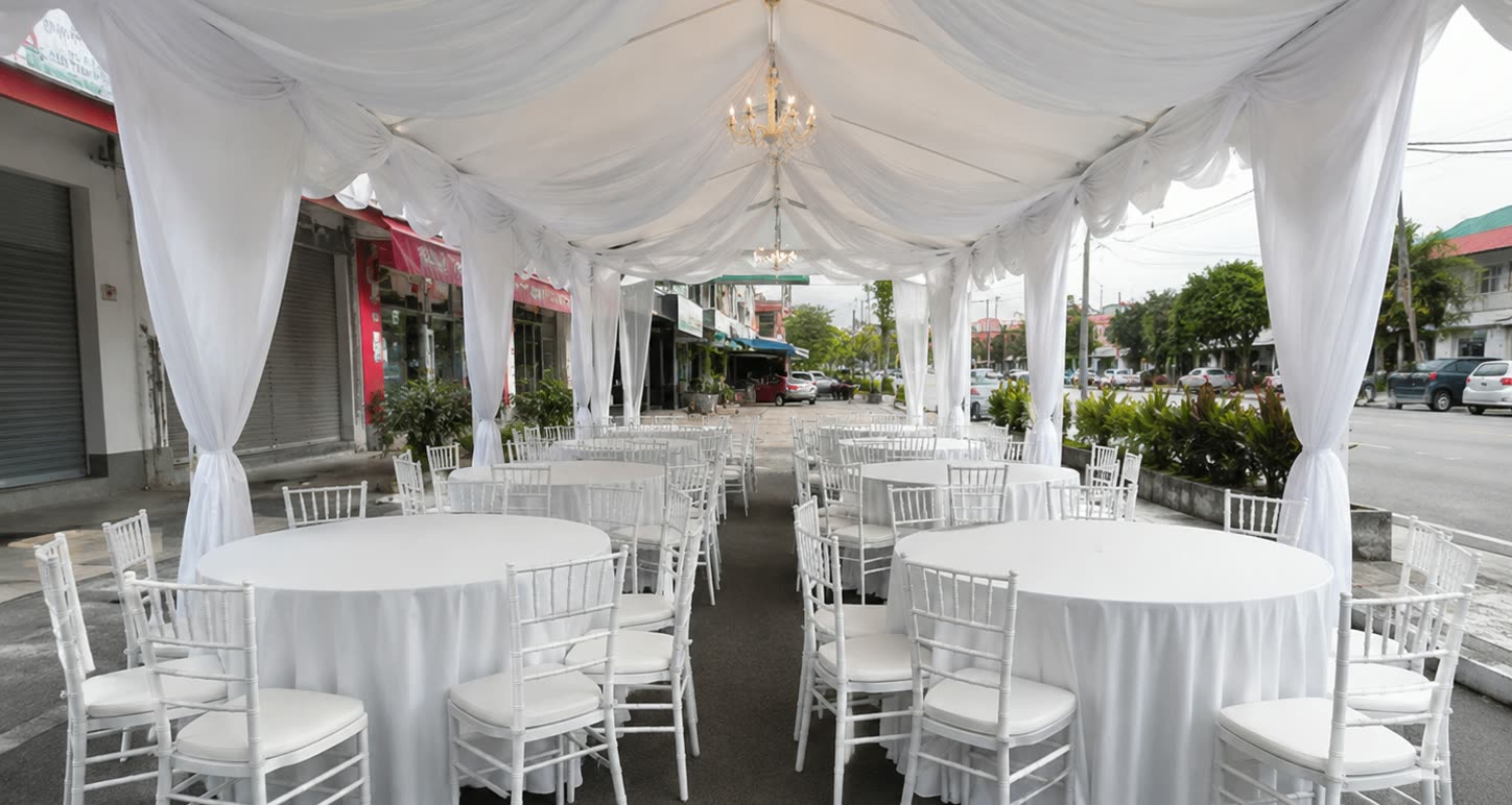 Pearl white walkway canopy dining setup beside a road with round tables and white chairs
